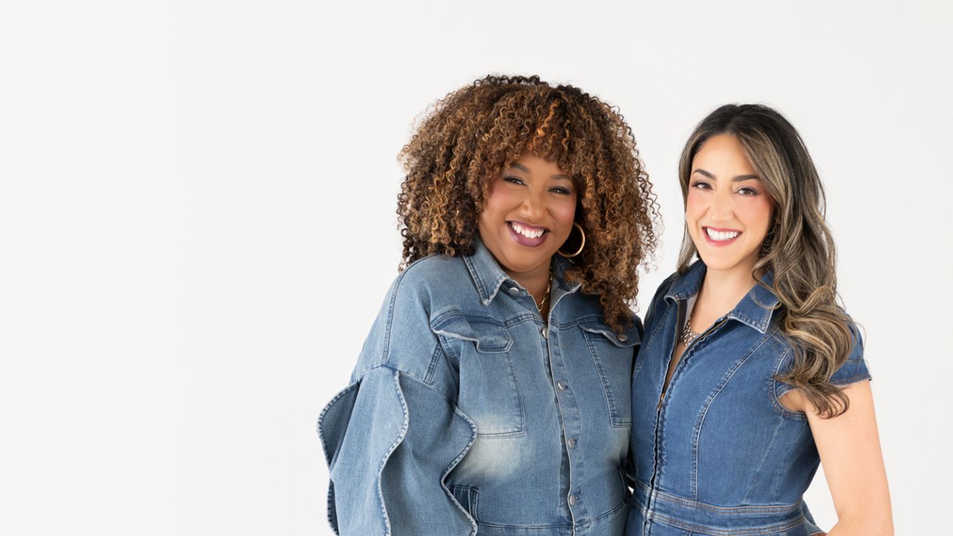 Kisha & Shana wearing denim standing side by side smiling with a white background